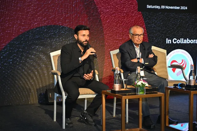 Two faculty members in discussion during a stage session