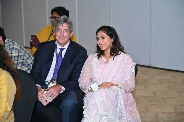 Two delegates seated together during a session