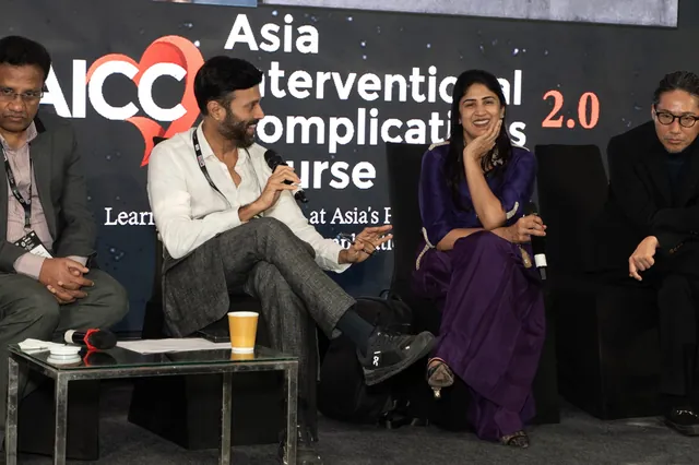 A panel discussion in progress, faculty seated on stage